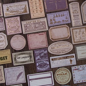 Vintage gold foil sticker set with antique labels on dark wood texture for DIY journals