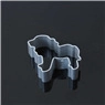Detailed view of a silver lion-shaped metal cookie cutter on a dark reflective surface