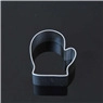 Detail of a metal glove-shaped cookie cutter on a dark background for DIY baking