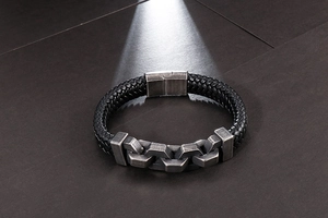 Detail of men's braided leather bracelet with vintage chain buckle and magnetic clasp