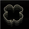 Close-up of heart-shaped stainless steel cookie cutter on a reflective black background