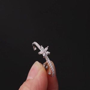 Fashionable flower zircon cartilage earring in silver steel worn on a finger