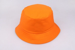 Top down view of bright orange cotton canvas bucket hat in minimalist Harajuku style