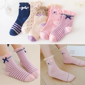 Detail of baby princess cotton socks with big bows and ruffles in navy, beige and pink