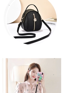 Detail of black lychee grain leather crossbody bag with rose gold metal charm and zipper