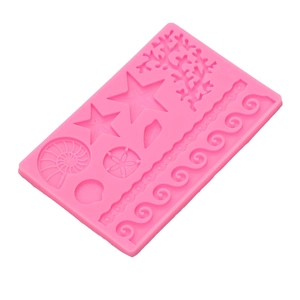 Pink silicone mold featuring marine shapes like starfish and shells for DIY cake baking