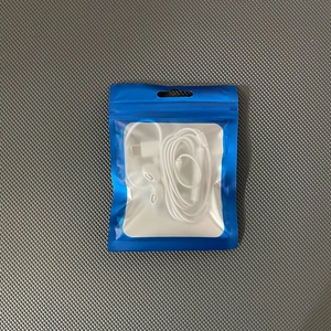 White in-ear headphones with 3.5mm plug in a blue matte-rimmed zip-lock packaging bag