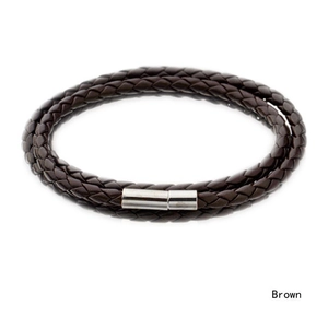 Macro detail of triple-layered woven brown leather bracelet with silver magnetic clasp