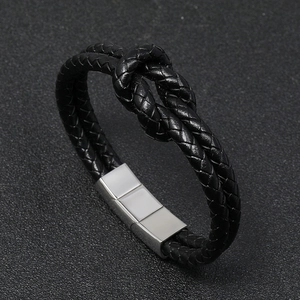 Detail of black braided leather bracelet with silver magnetic stainless steel clasp