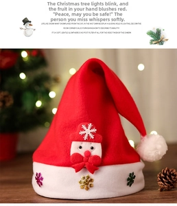 Detail of Christmas plush hat featuring snowman face applique and glittery snowflakes