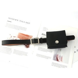 Fashionable black leather waist belt with mini square pouch and silver buckle on magazine