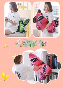 Detail view of large green and pink butterfly plush pillows held in a decorative setting