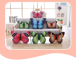 Set of colorful butterfly plush pillows in various sizes on a sofa for room decoration