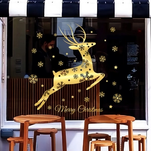 Golden Christmas reindeer glass stickers with snowflakes on a cozy cafe window display