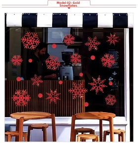 Close-up of red snowflake window decals with hollow art design on a cafe glass storefront