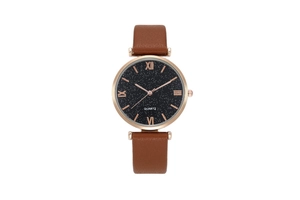 Detailed macro view of the rose gold round metal case and celestial star theme dial