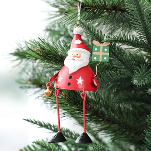 Christmas Santa metal tree ornament with golden bell and green gift bag on tree branch