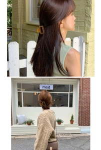Detail showing amber leopard print acetate hair claw clip styled in a half-up hair bun