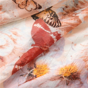 Macro detail of butterfly print fabric with golden lurex stripes and gradient texture