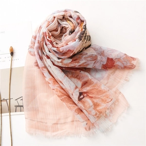 Close-up of peach butterfly floral scarf featuring raw edges and soft chiffon texture