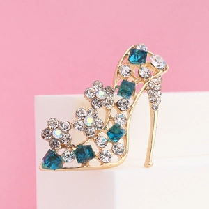 Close-up of high heel brooch with navy crystal and rhinestone floral detail