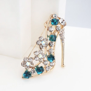 Macro shot of high heel brooch with blue crystals and sparkling floral rhinestones