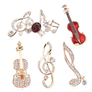 Elegant musical note and violin brooch set with rhinestones and pearls on gold finish