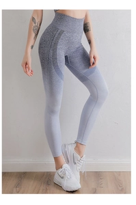 Detail of high-waisted seamless yoga pants with grey-blue gradient and ribbed texture