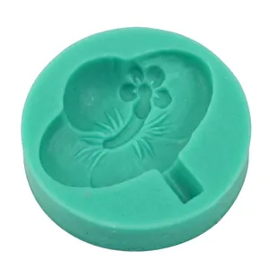 Macro view of green round silicone fondant mold with petal pattern for cake baking