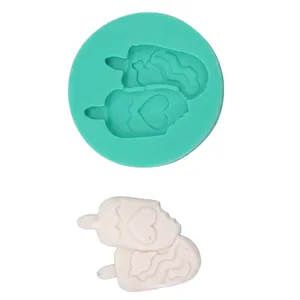 Detailed mint green silicone mold and finished cartoon animal fondant cake tool