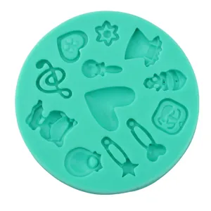 Macro detail of mint green silicone mold with heart, pin, and musical note shapes