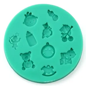 Detail of round green silicone mold with baby-themed teddy bear and rocking horse shapes