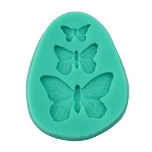 Detail view of the green silicone mold featuring three different butterfly sizes