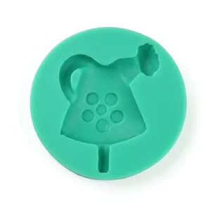 Detailed top view of a green silicone mold featuring a teapot shaped cavity for baking