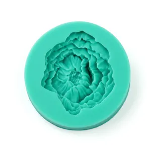 Detailed macro view of a teal green silicone rose flower mold for fondant and DIY crafts