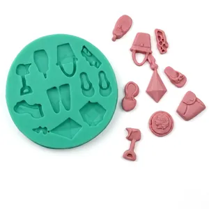 Macro detail of silicone mold with pink fashion accessory shapes like handbags and shoes