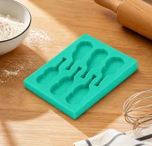 Detail view of teal silicone mold featuring various guitar and musical instrument shapes