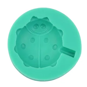 Macro shot of a green silicone ladybug mold with detailed carving for DIY crafts