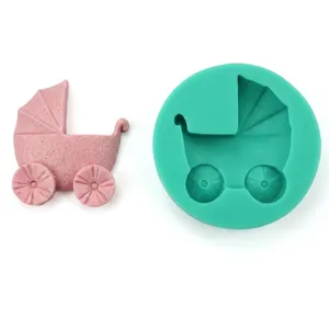 Detail view of round green silicone mold and a pink stroller shaped fondant creation
