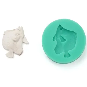 Green silicone mold for DIY baking with palm-shaped bird fondant detail and white sample