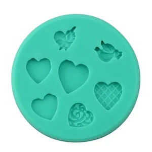 Detail of green silicone mold with multiple heart-shaped cavities for DIY baking
