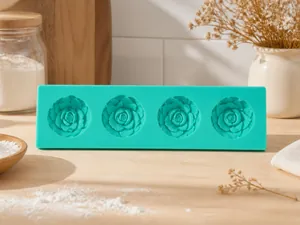 Top view of green silicone cake mold with four detailed floral rose cavities for baking