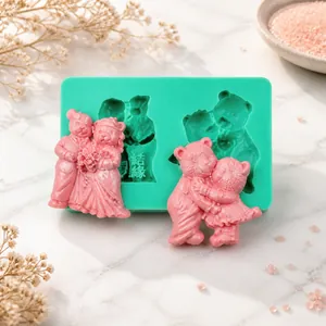 Detail of green silicone mold with pink bear and couple embossed fondant cake toppers