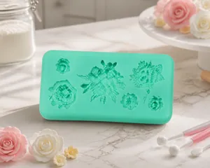 Macro detail of mint green silicone mold with floral leaf patterns for fondant cake decorating