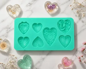 Detail of mint green silicone mold featuring multiple textured heart shapes for baking