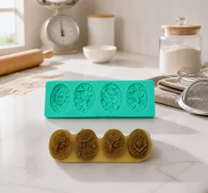 Detailed macro view of 4-cavity floral silicone mold and brown finished soap pieces