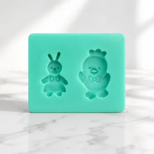Detail of green silicone mold featuring cartoon rabbit and crowned duck for DIY baking