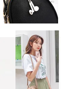 Detail of lychee textured leather mini bags showing headphone port and golden zippers