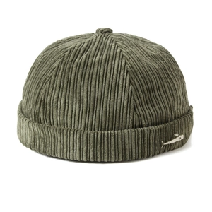 Detail of army green corduroy docker cap featuring a small white fish embroidery