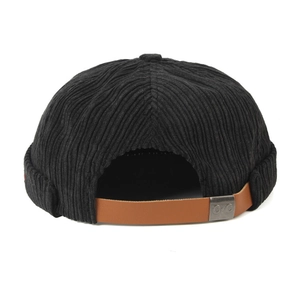 Detail of adjustable brown leather strap and metal buckle on black corduroy docker hat